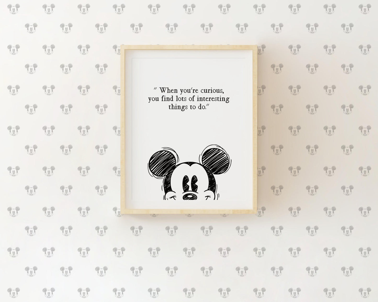 Single framed nursery print featuring Mickey Mouse head illustration and the quote When you are curious you find lots of interesting things to do