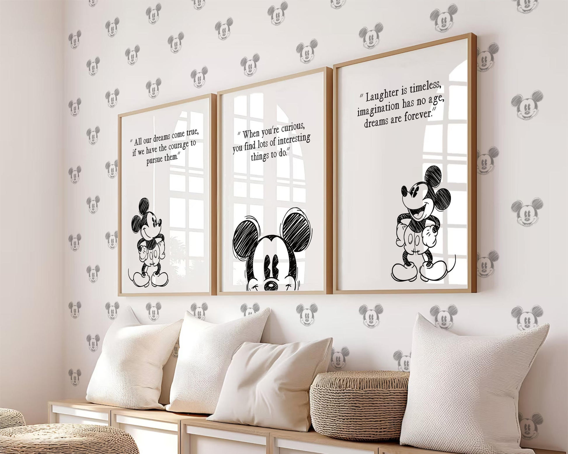 Three framed Mickey Mouse prints with inspirational Disney quotes styled above a seating area in a nursery room