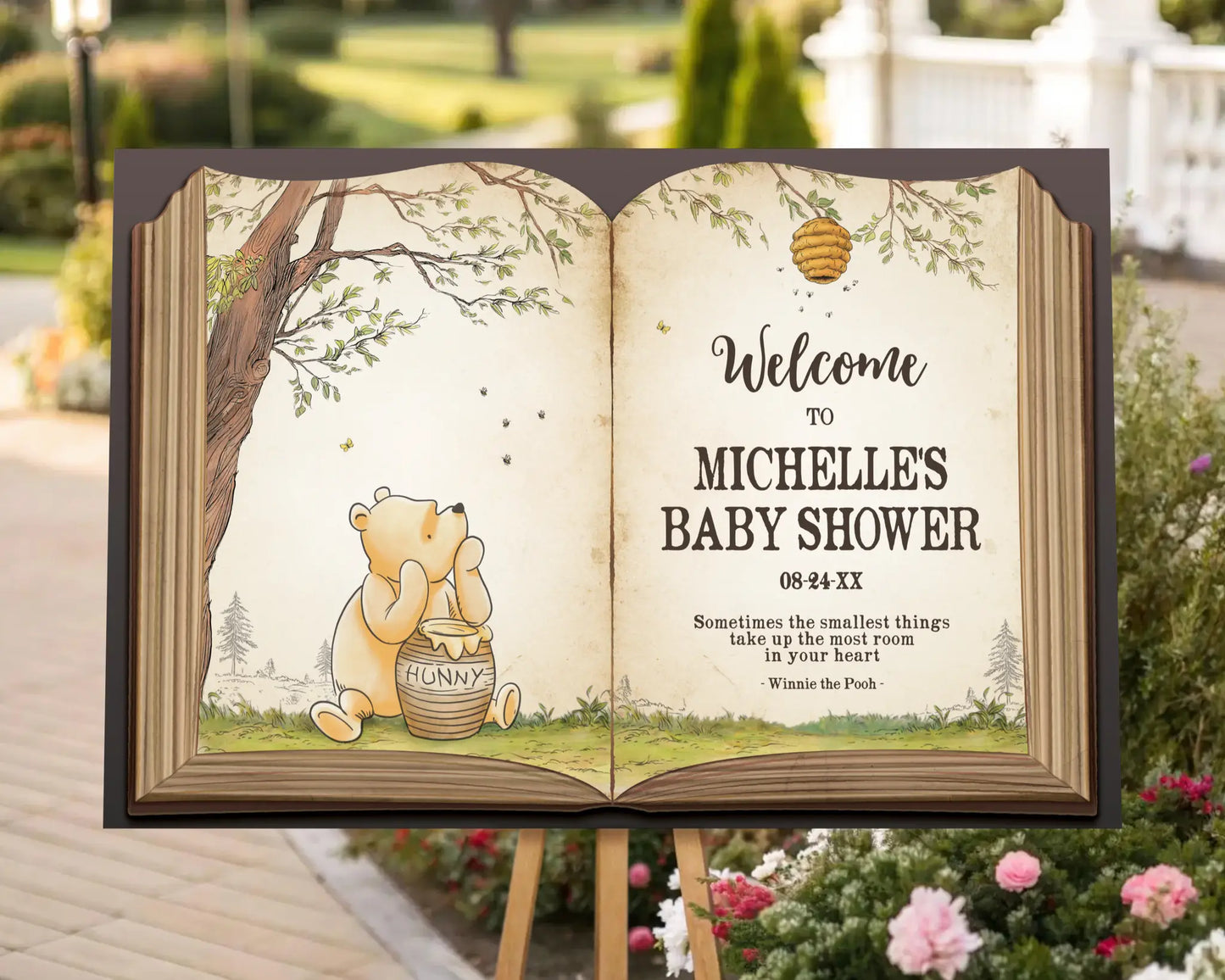 Close-up of Winnie the Pooh welcome sign for baby shower, showing Pooh Bear illustration and honey pot under a tree branch.
