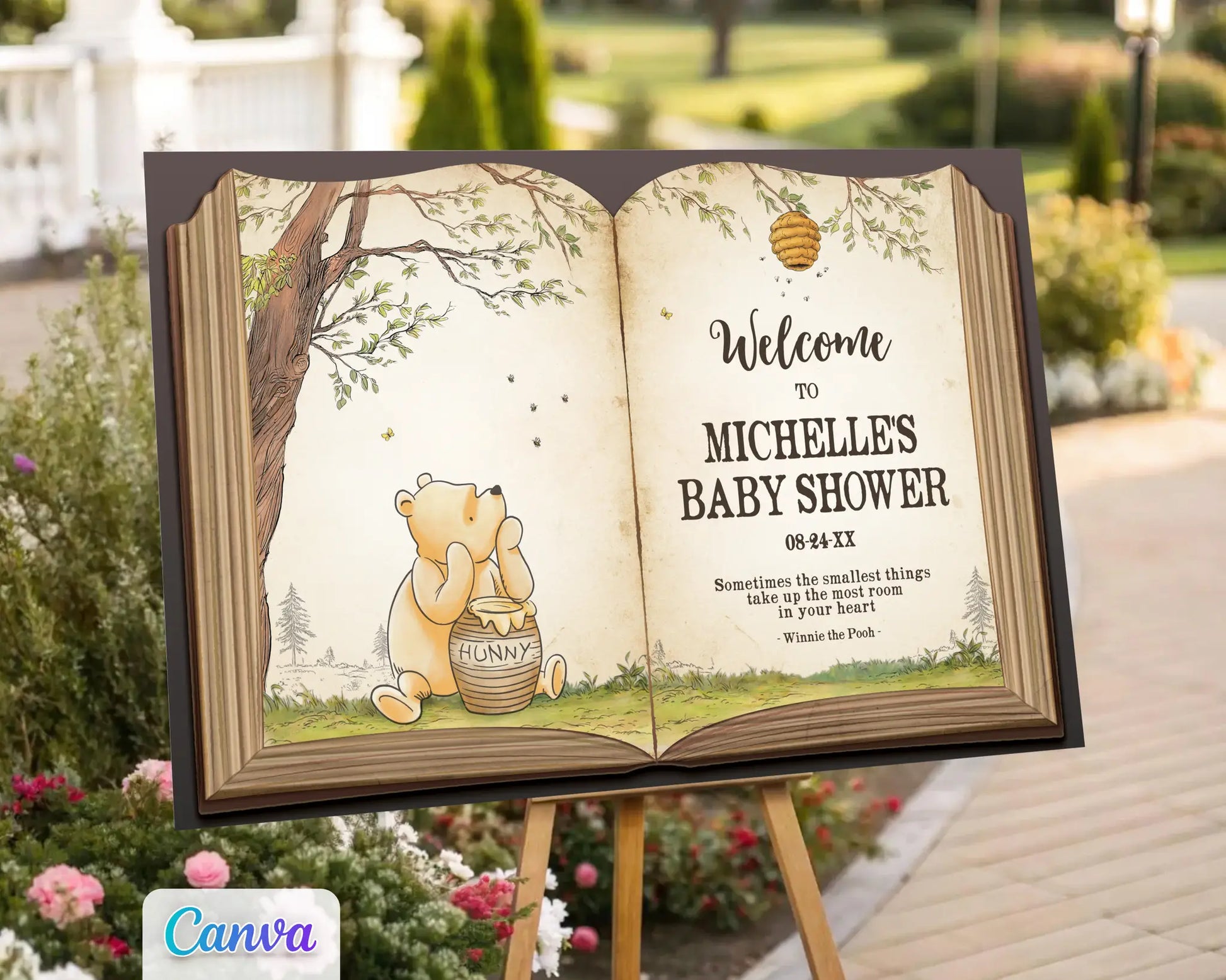 Winnie the Pooh baby shower welcome sign displayed outdoors on an easel surrounded by flowers, featuring Pooh Bear with a honey pot in a storybook design.