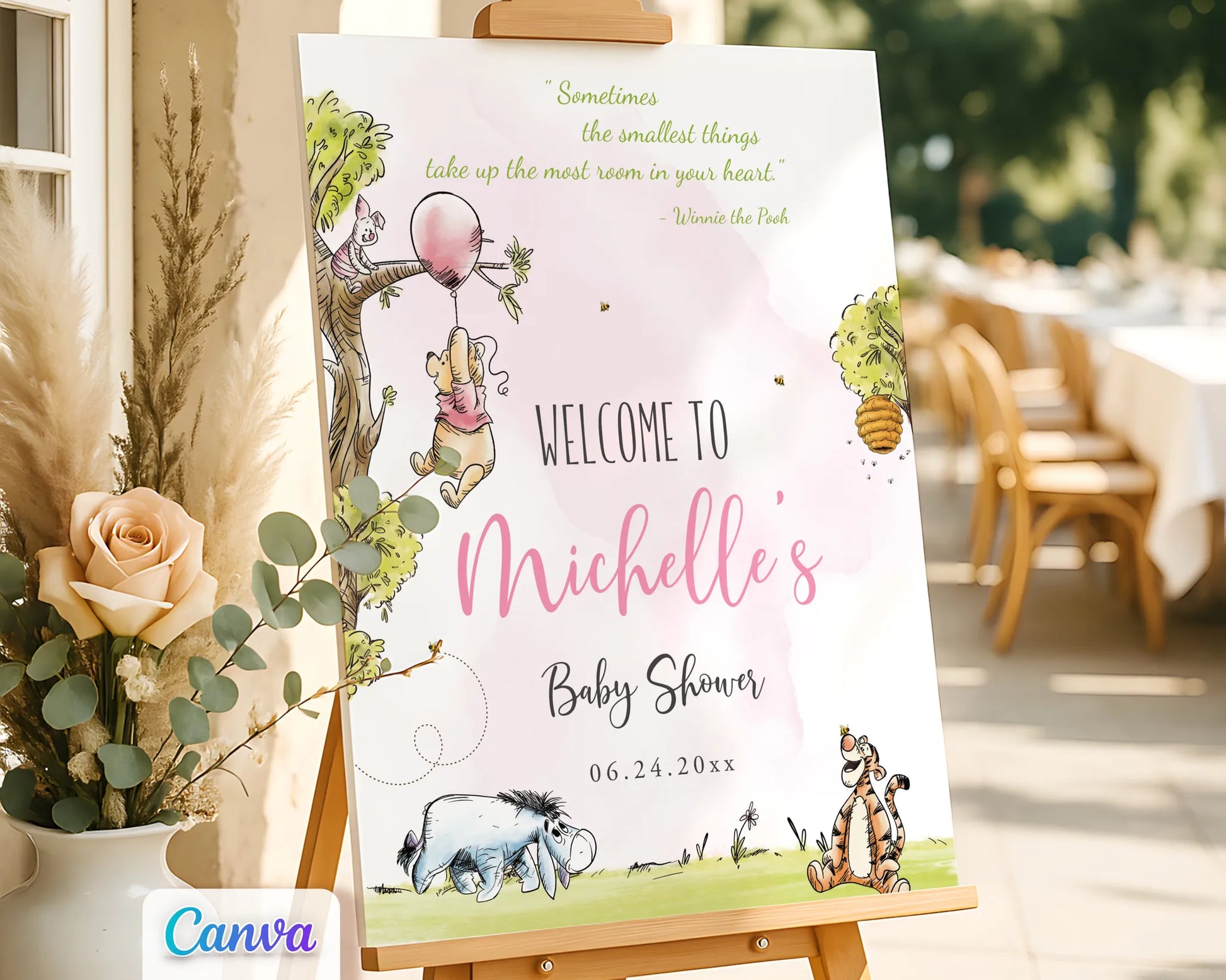 Watercolor Winnie the Pooh baby shower girl welcome sign on an easel in an outdoor setting